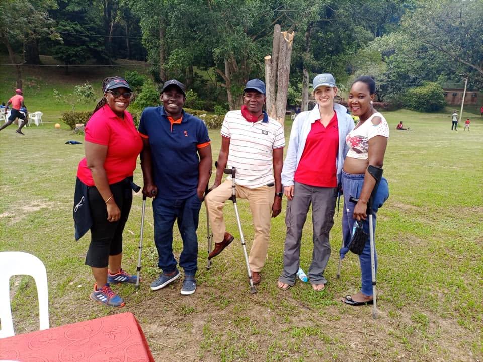 Federation members and athletes pose together outdoors.