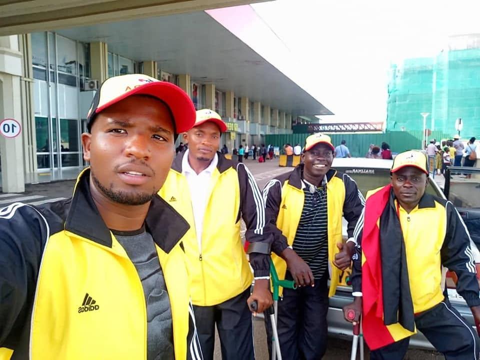 Federation members in team kit stand together outside a building.