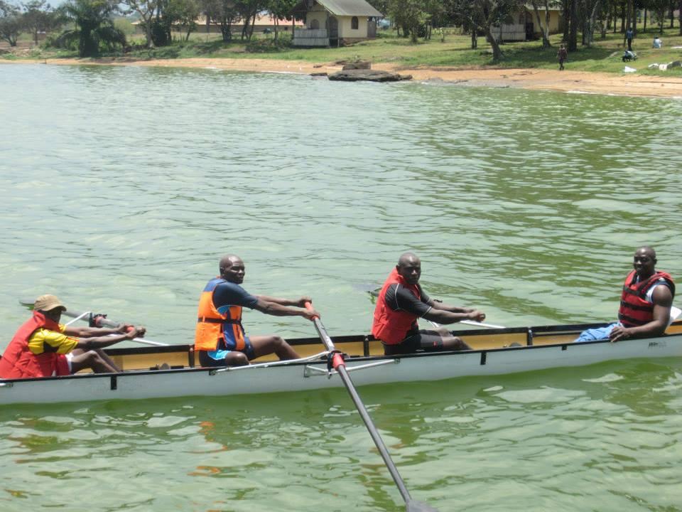 A crew of Para rowing athletes and a coxswain row together on the water.